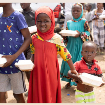Children receiving food donations in Ghana